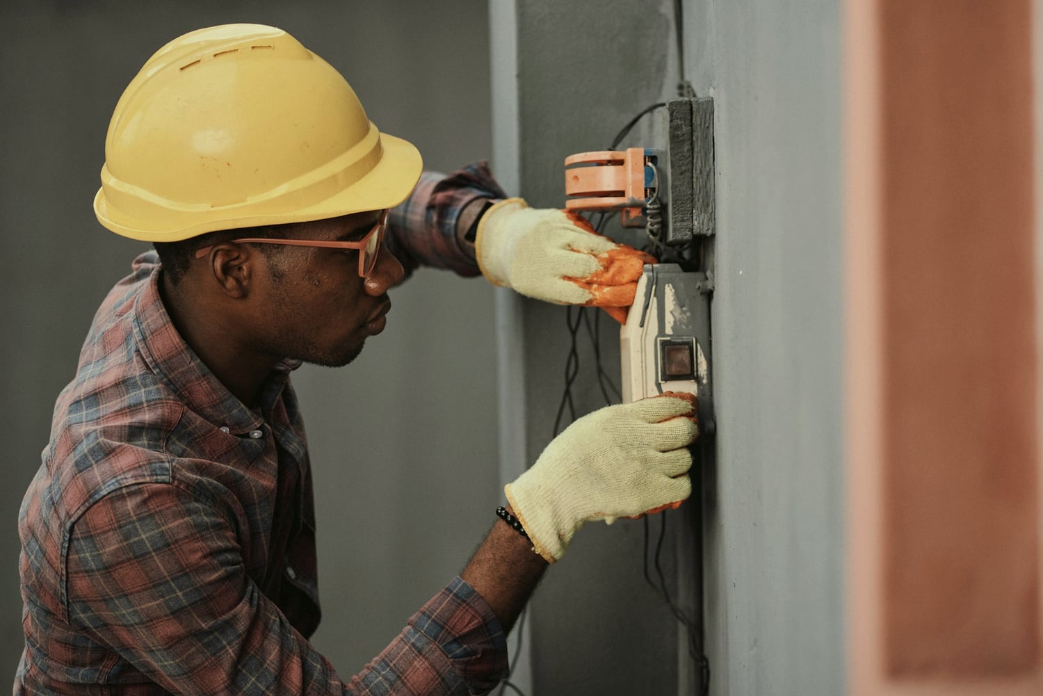 Electrician working on an exterior electrical panel